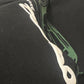 Black hoodie with a puff print graphic design on the chest