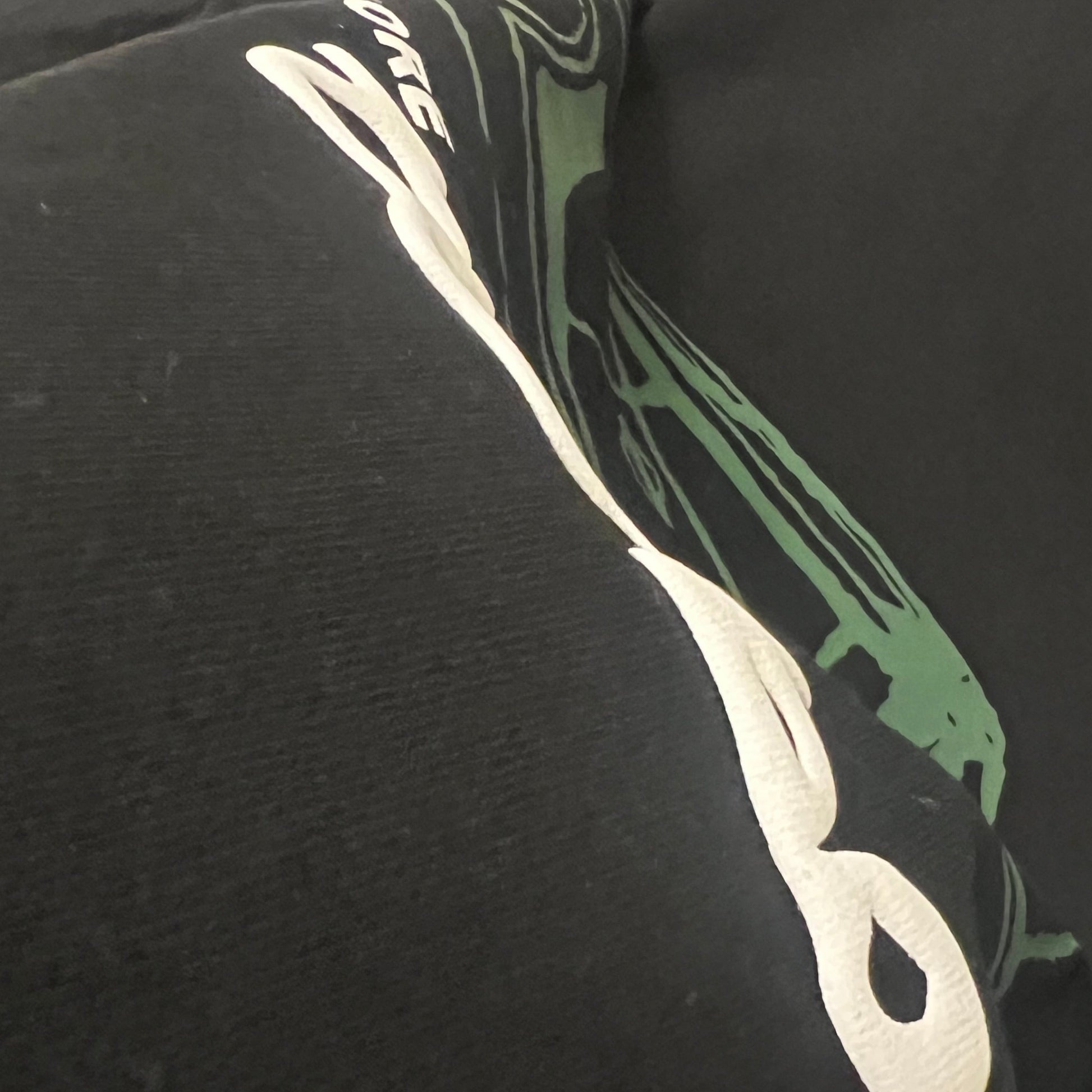 Black hoodie with a puff print graphic design on the chest