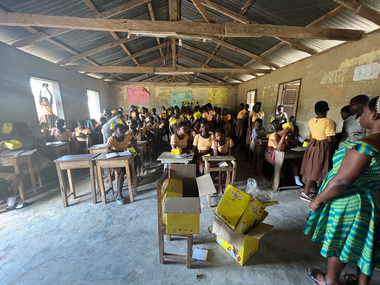 A class of ghanaian girls receiving two sanitary packs each provided by more amoure through more action